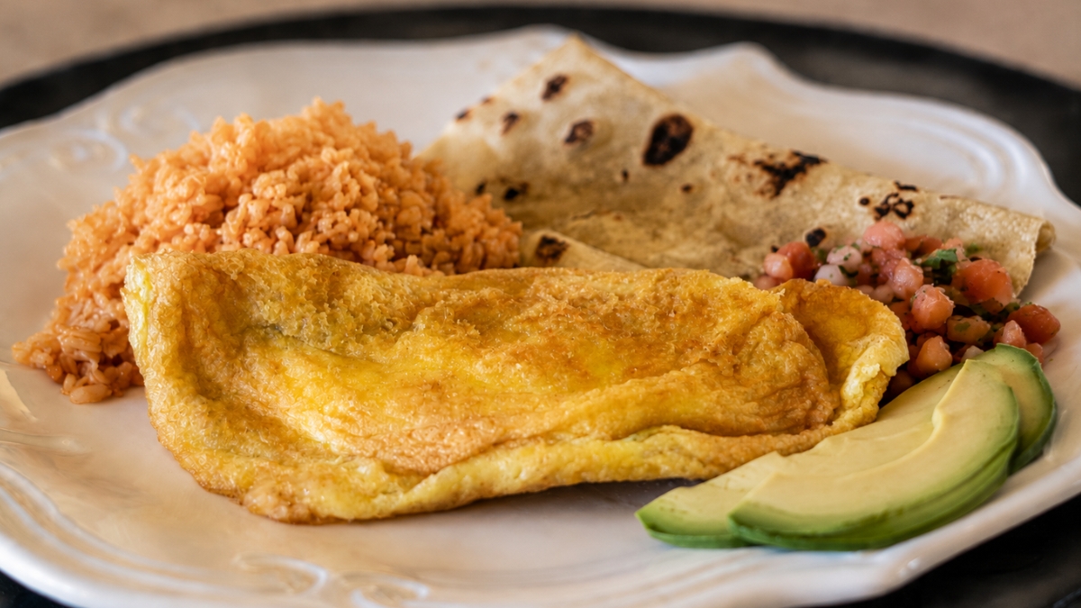 Rosella&rsquo;s chile rellenos served with rice, tortillas, salsa, and avocado